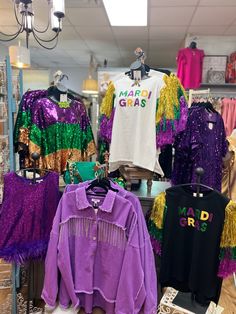 purple and green shirts are on display in a store