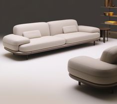 a white couch and chair sitting next to each other