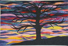 a quilt with a tree on it in the middle of a field and colorful clouds