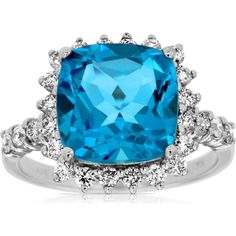 a blue topazte and diamond ring with white diamonds on the sides, set in 18k white gold