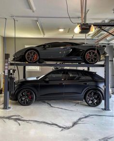 two cars parked on top of each other in a garage