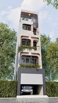 a tall building with balconies and plants growing on the top floor, next to a parking garage