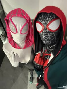 two mannequins dressed in spider - man costumes