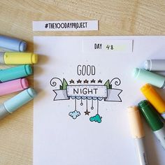 some crayons and markers are on the table next to a sheet of paper that says good night