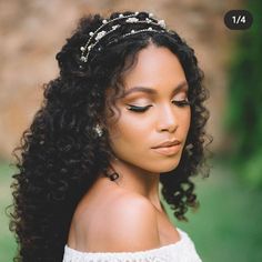 a woman with long curly hair wearing a tiara and pearls on her head is looking off to the side