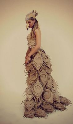 a woman in a dress made out of hats