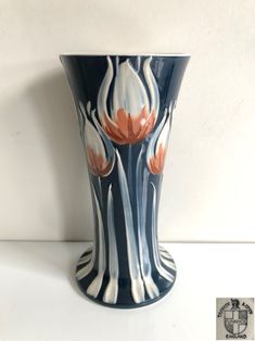 a blue and white vase with flowers painted on it