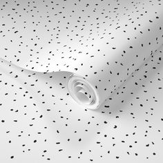 a white surface with black dots on it