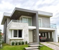 a car is parked in front of a modern house