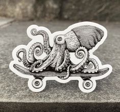 an octopus riding a skateboard on top of a cement slab in black and white