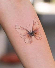 a small butterfly tattoo on the arm