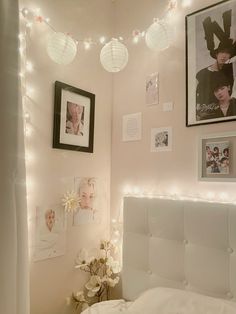 a bedroom with lights and pictures on the wall