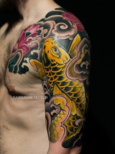 a man with a tattoo on his arm has a gold fish in it's body