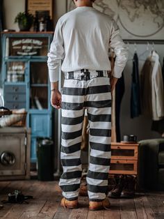 The pants feature a black and white wide stripe colorway with an Axman vintage style from the 1930s and 1940s. Made from colorblocked 16 oz. canvas cotton, they feature front slash pockets and two back patch pockets, a zipper closure, a high waist, and a slightly loose fit for a comfortable wear. It will show a retro and old look over time, and the black will turn into dark gray FEATURES 100% Cotton 2 front slash pockets Engraved strong metal buttons Vintage martingale belt on the back Japan YKK Black And White Striped Pants, Denim Overalls Shorts, Wide Stripes, Chino Jeans, Pants For Men, Parka Coat, Vintage Pants, Denim Overalls, Chinos Pants