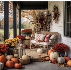 a porch with pumpkins and gourds on it