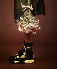 a pair of black shoes with flowers in them on top of a skirt and jacket