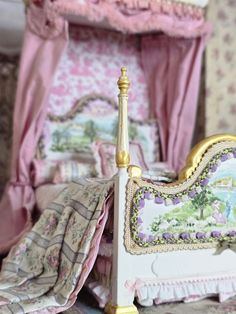 there is a doll house bed with pink and gold furniture