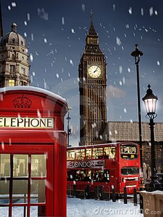 a red phone booth in the snow with big ben in the background