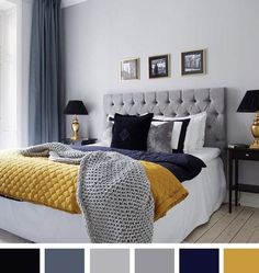 a bedroom with blue and yellow colors on the walls, white bedding, gray headboard