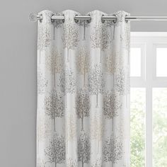 a white curtain with silver trees on it