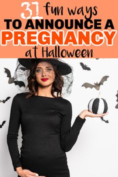 a pregnant woman wearing a witches hat and holding a ball with bats on it