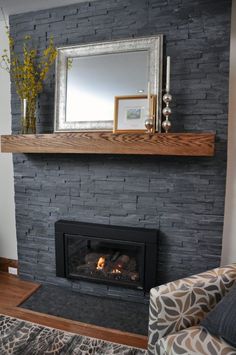 a living room with a fire place in the center and a mirror on the wall