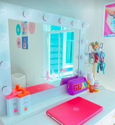 a bathroom vanity with a laptop and mirror