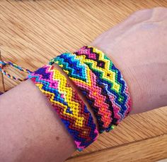 a person's arm with two colorful bracelets on it