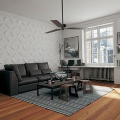 a living room with wood flooring and white wallpaper, including a black leather couch