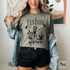 The perfect T that is a blend of spooky and sassy with our 'Yeehaw Witches' Halloween shirt! This Comfort Colors tee brings retro cowgirl witch vibes, perfect for women who love vintage style with a Halloween twist. Whether you're heading to a Halloween bash or just showing off your witchy vibes, this soft, durable t-shirt makes a great gift for her. Designed for comfort and style, it's the ideal choice for the season. The Comfort Colors 1717 is the ultimate garment-dyed t-shirt, made 100% with Cowgirl Witch, Witch Tshirt, Retro Cowgirl, Witches Halloween, Witch Vibes, Halloween Bash, Vintage Cowgirl, Witchy Vibes, Comfort Colors Tee