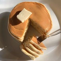 a pancake cut in half on a plate with a fork