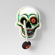 a colorful skull head hanging on a rope