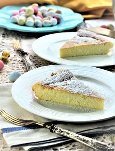 two white plates topped with slices of cake