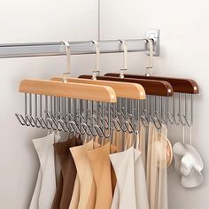 there is a rack with clothes hanging on it and two cups next to the hangers