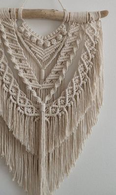 a macrame hanging from a wooden hanger