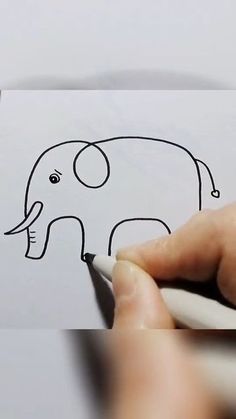 someone is drawing an elephant on paper