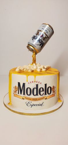 a modelo beer can being poured into a cake