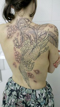 a woman with a tattoo on her back