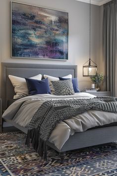 a bedroom with a large painting on the wall above the bed and rug below it