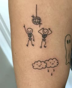 a person with a tattoo on their leg that has two stick figures in the sky above them