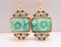 Earrings with glass paste roses: a touch of romance and refinement. These dangling earrings are a true jewel of romance and refinement. The delicate glass paste roses, sculpted in antiqued jade green medallions, faithfully reproduce the style and elegance of Bakelite jewels. Details: *Material: French alloy "Demirouge" (copper 85%, zinc 15%) gilded in 14 carat gold, antiqued jade green glass paste, original European crystals (emerald green, brilliant white) *Dimensions: Length 3.6 cm - 1.42 inches, width 1.9 cm - 0.75 inches *Weight: 9.4 g (the pair) - 0.34 ounces (the pair) *Handmade in Italy Characteristics: * Romantic and elegant design with glass paste roses * Genuine European crystals for a touch of sparkle * Hypoallergenic and resistant French "Demirouge" alloy * 14K gold plating tha Vintage Green Jeweled Earrings, Ornate Green Jewelry For Evening, Elegant Green Flower Earrings, Elegant Jeweled Green Earrings, Elegant Green Jeweled Earrings, Elegant Green Flower Earrings For Wedding, Vintage Gold Earrings For May Birthstone, Elegant Green Flower Earrings For Formal Occasions, Elegant Green Flower Earrings For Gift