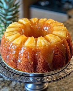 a pineapple upside down cake sitting on top of a metal stand