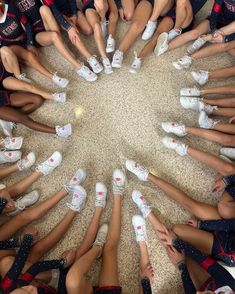 a group of cheerleaders standing in a circle