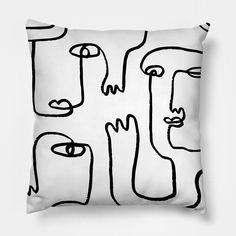 a black and white pillow with faces drawn on it