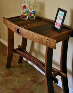 a wooden table with an ipad on it in the middle of a living room area