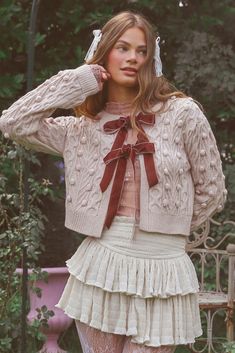 a woman in tights and stockings is posing for the camera with her hands on her head