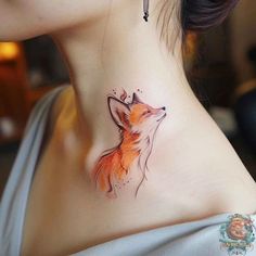 a woman's neck with a tattoo of a fox on it