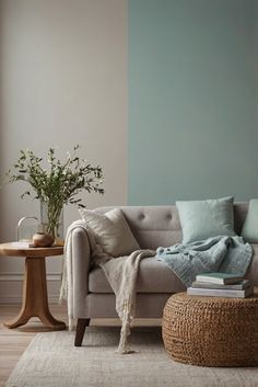 a living room with a couch, coffee table and plant on the floor in front of it