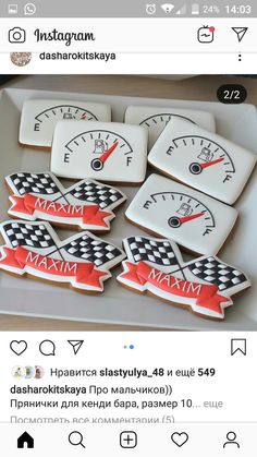 some cookies are sitting on a tray with the words mam spelled in russian and two speedometers