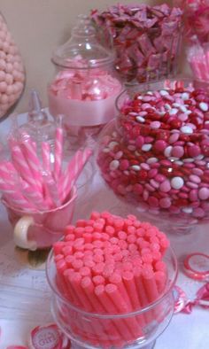 pink and white candies in glass bowls on a table